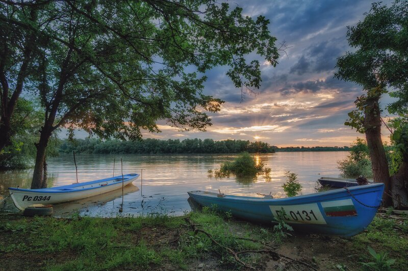 Blue Boats on Riverbank