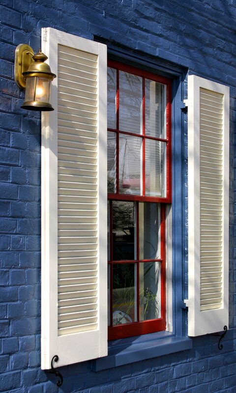 blue brick house with red window