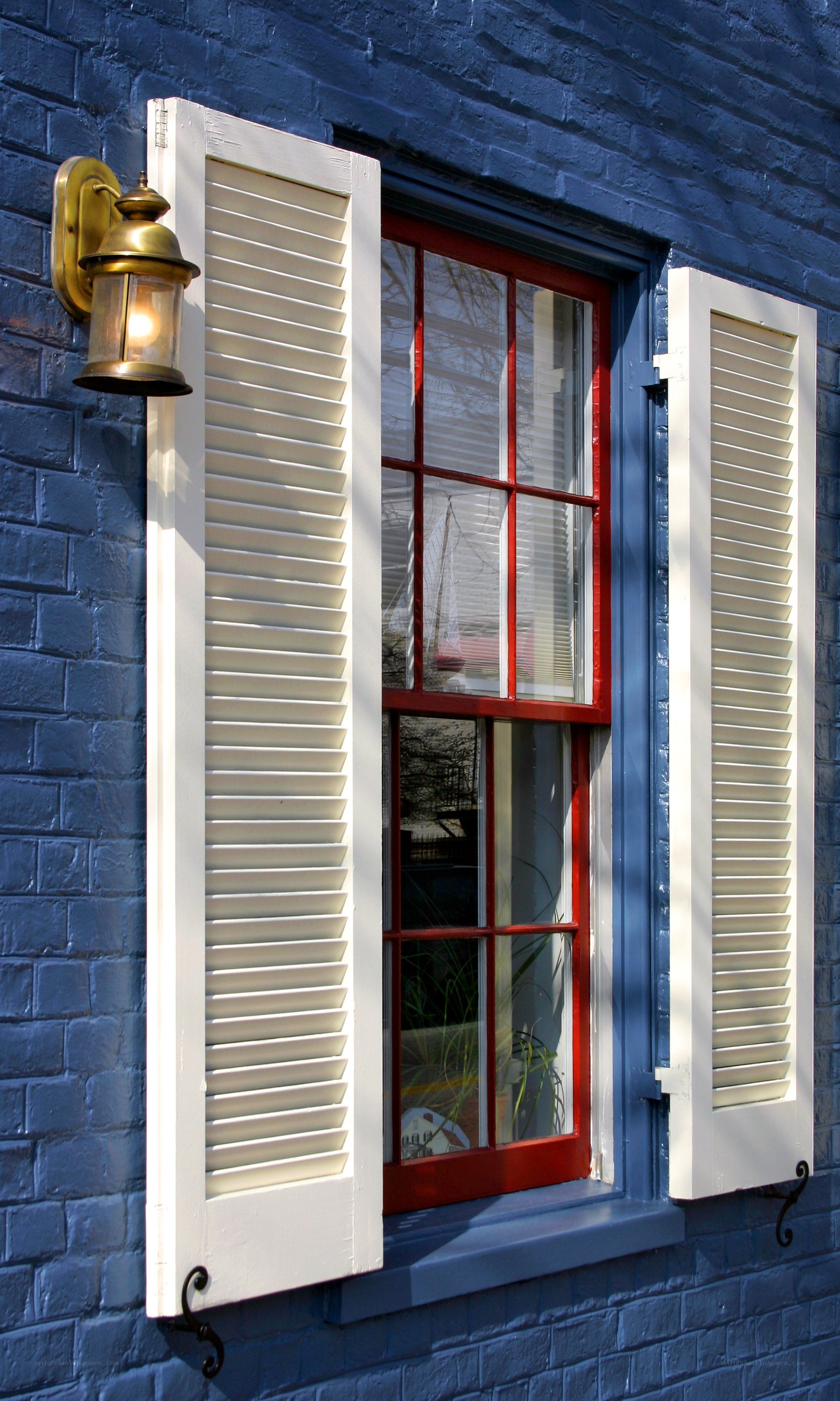 blue brick house with red window