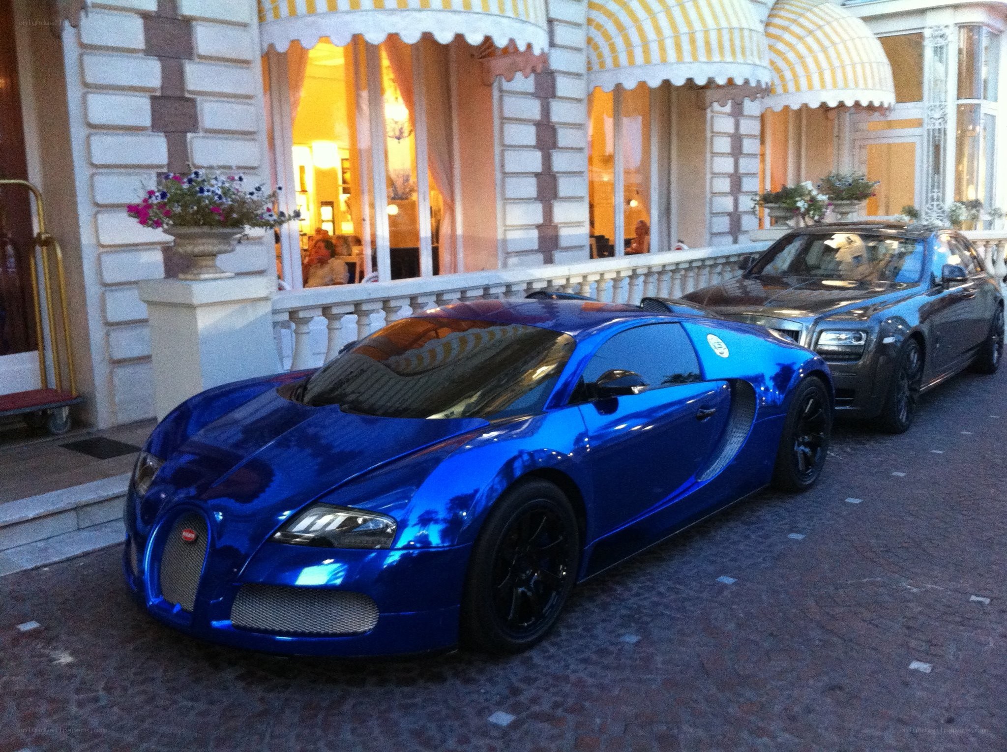 Blue Bugatti and Rolls-Royce parked