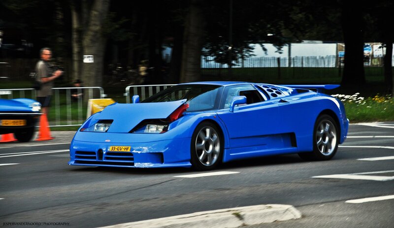 Blue Bugatti EB110 on a road
