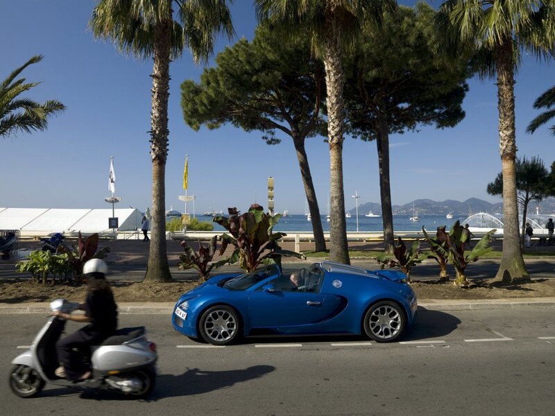 Blue Bugatti on a coastal road
