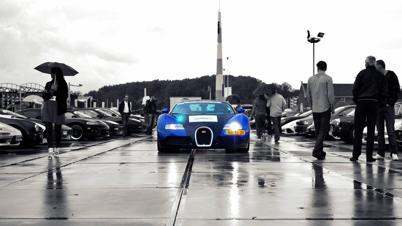 Blue Bugatti on wet pavement