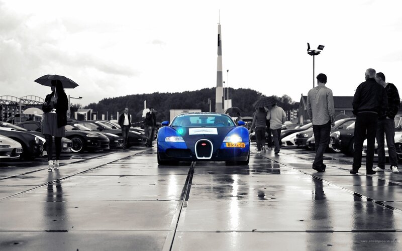 Blue Bugatti on wet pavement