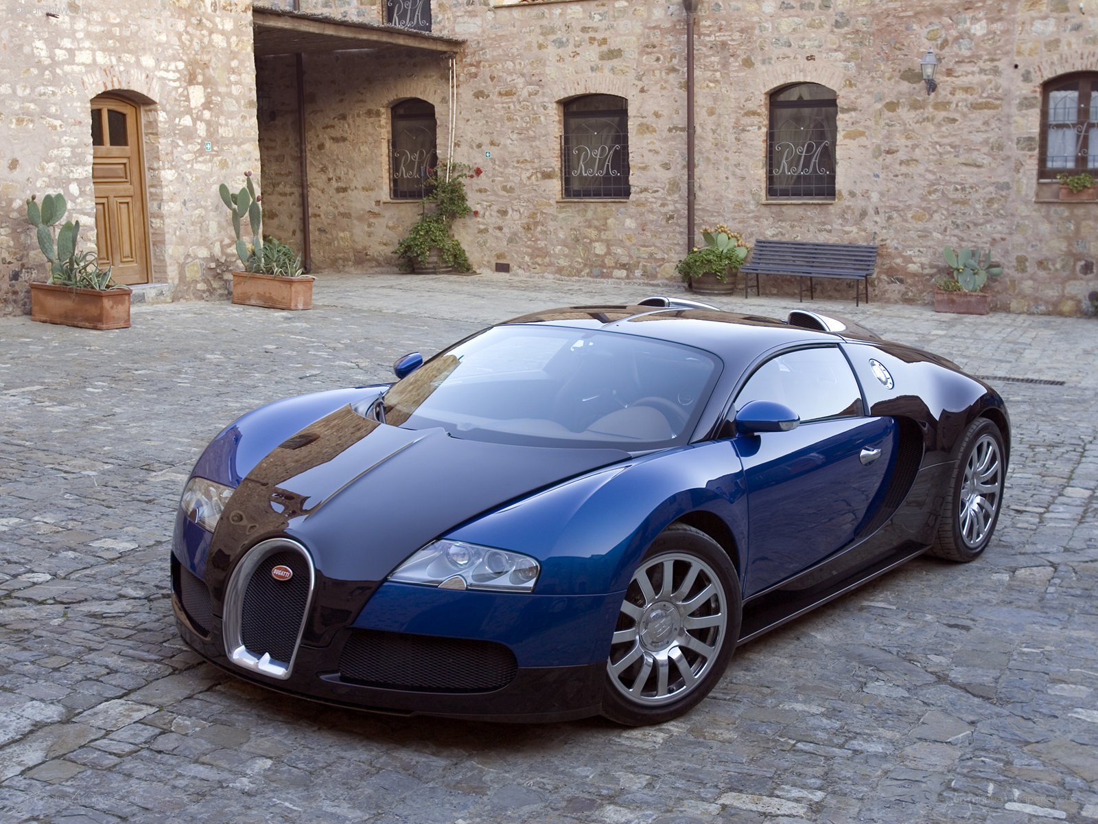 Blue Bugatti Veyron in courtyard