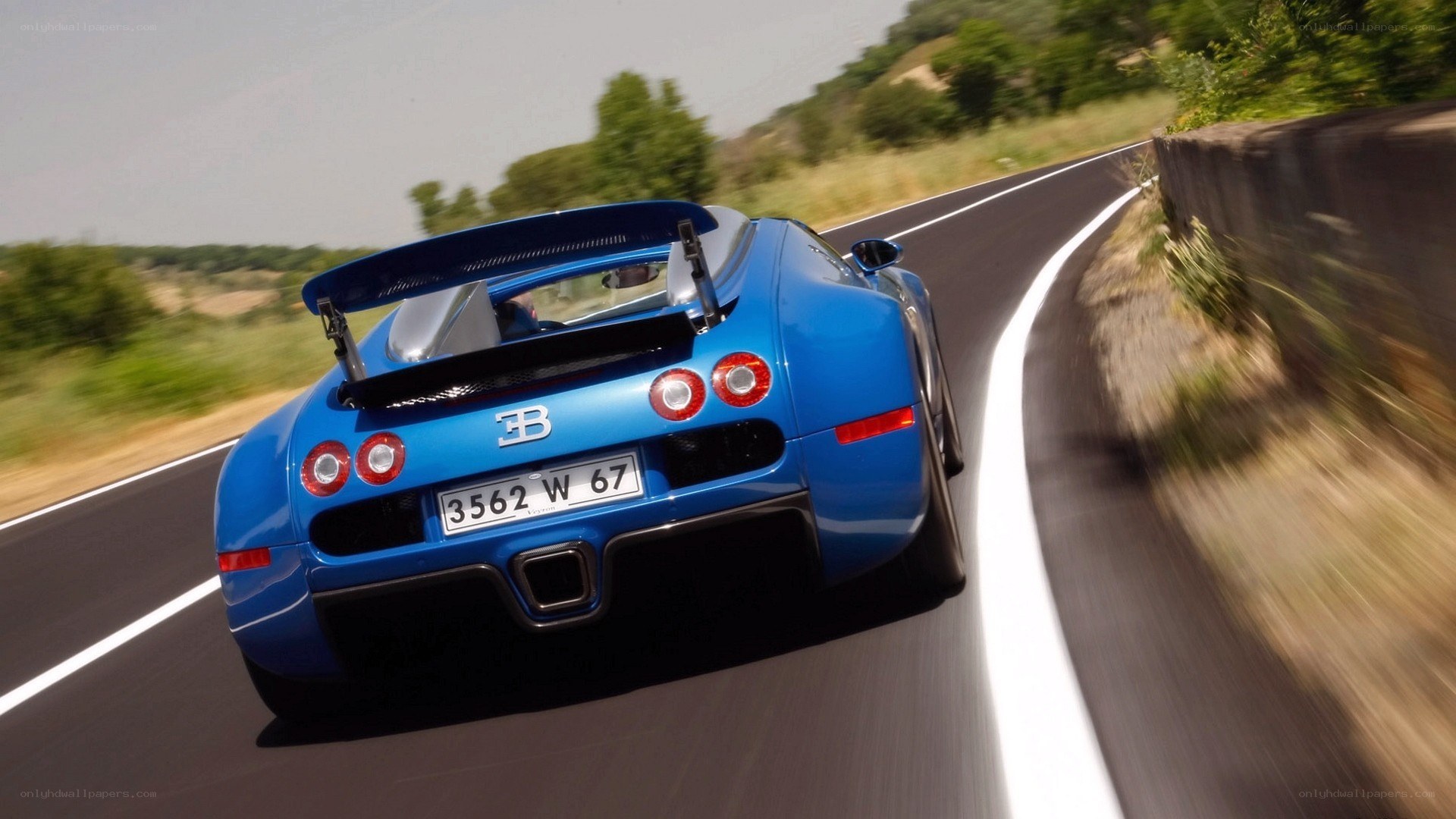Blue Bugatti Veyron on a winding road