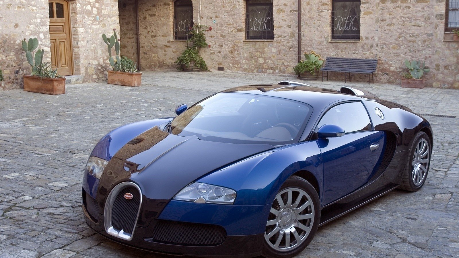 Blue Bugatti Veyron on cobblestones