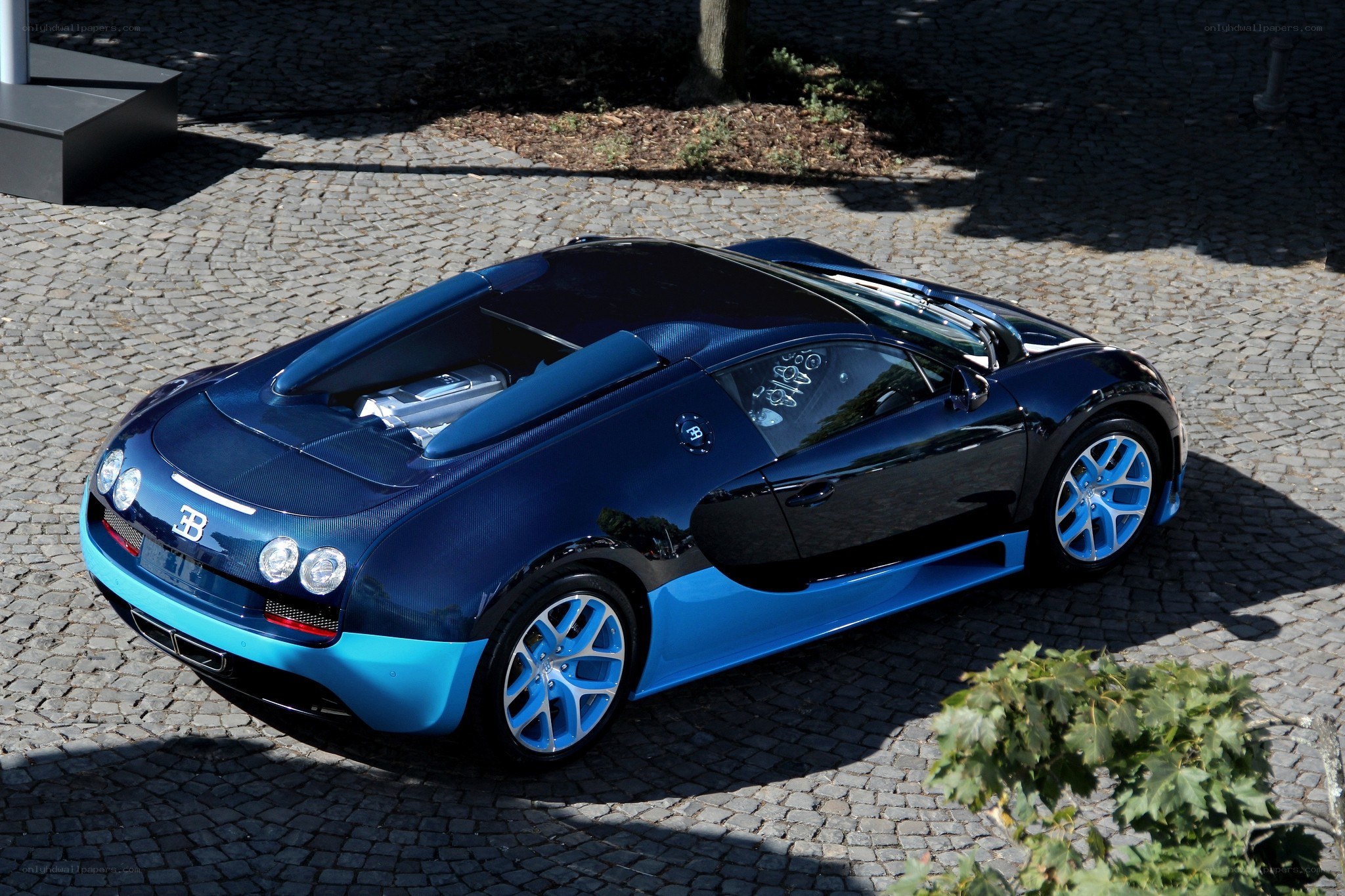 Blue Bugatti Veyron on cobblestones