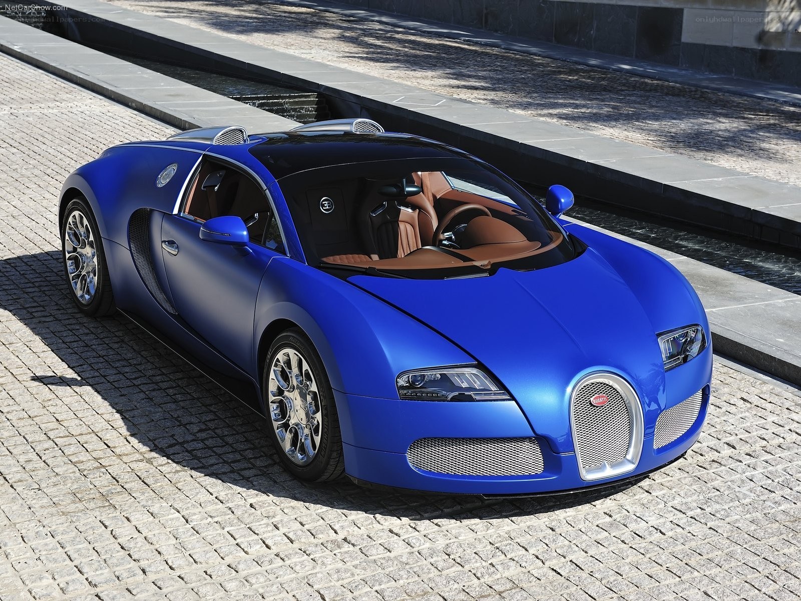 Blue Bugatti Veyron on cobblestones