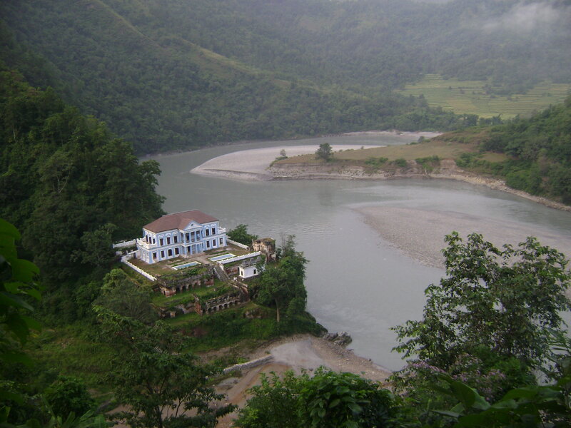 Blue Building on Riverbank