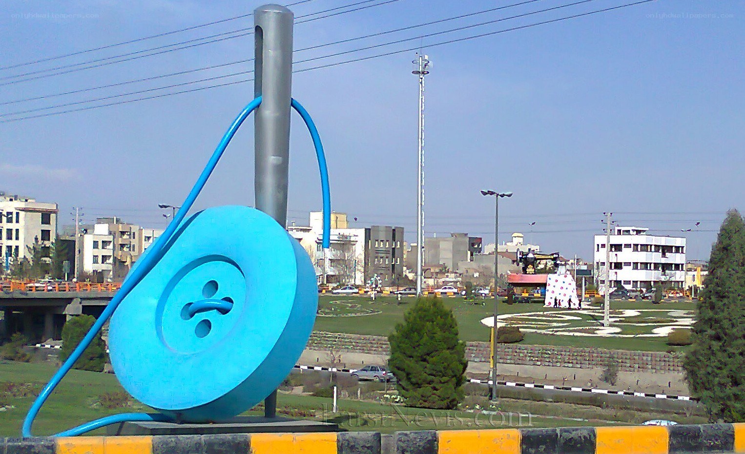 blue button sculpture in city