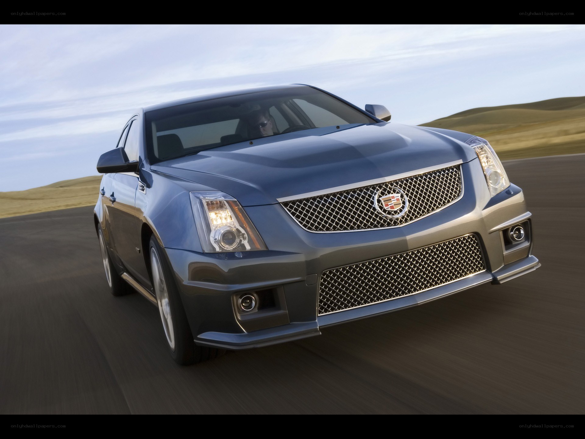 blue cadillac in motion
