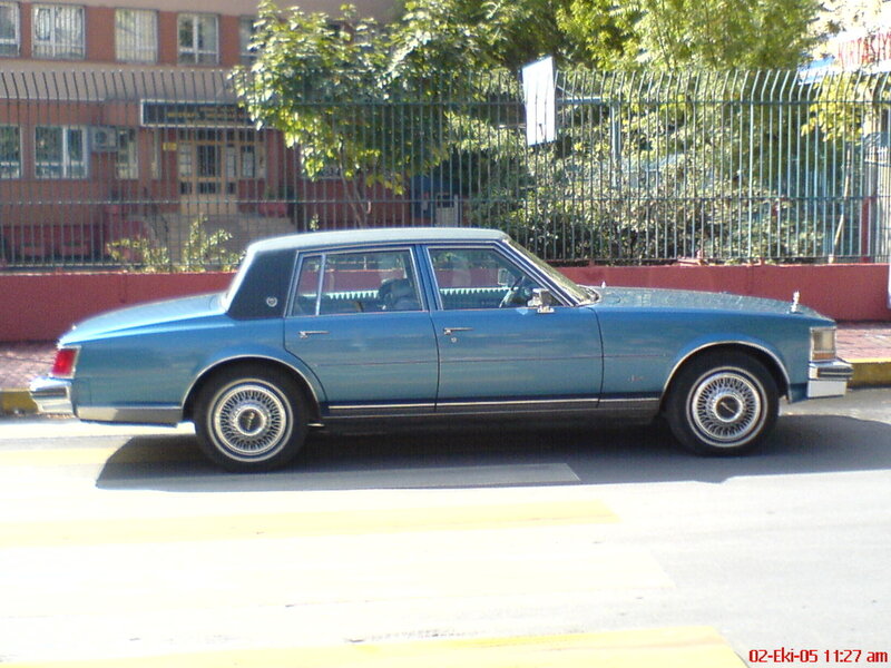 blue cadillac sedan on street