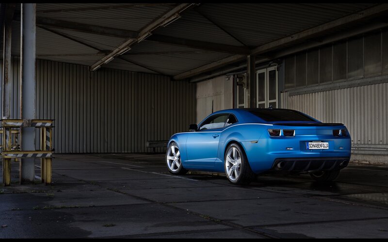 Blue Camaro in a warehouse