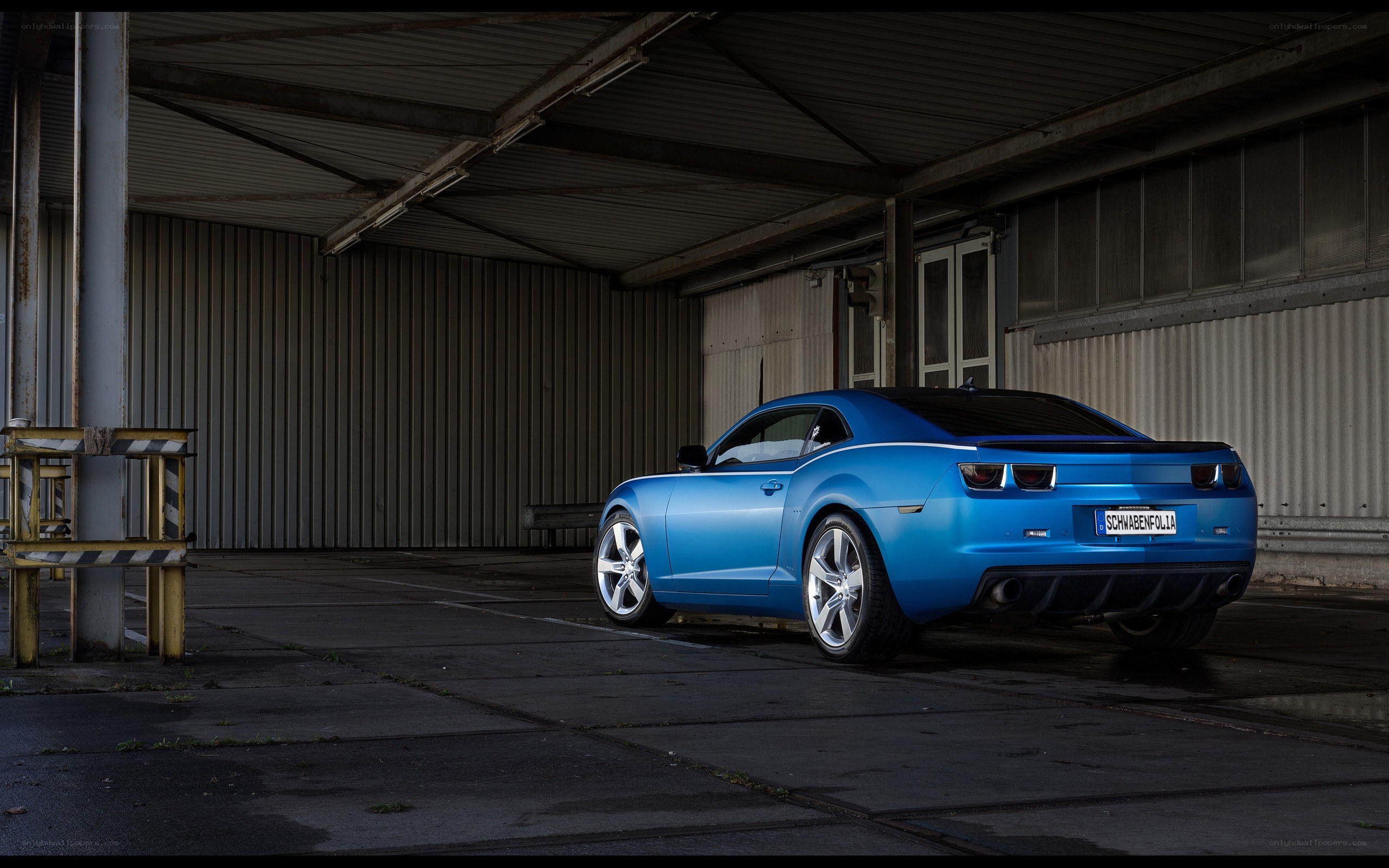 Blue Camaro in a warehouse