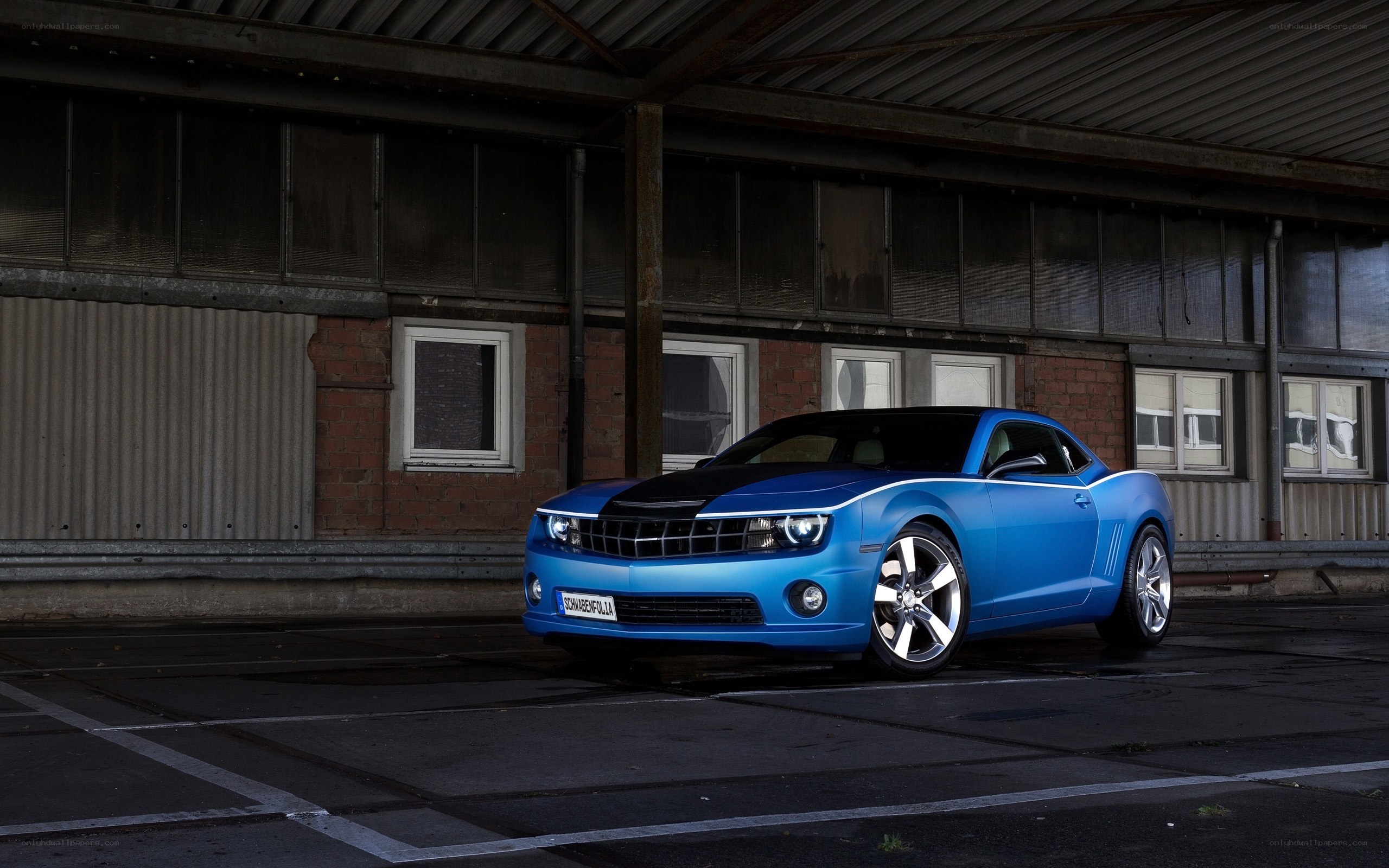 Blue Camaro in industrial setting