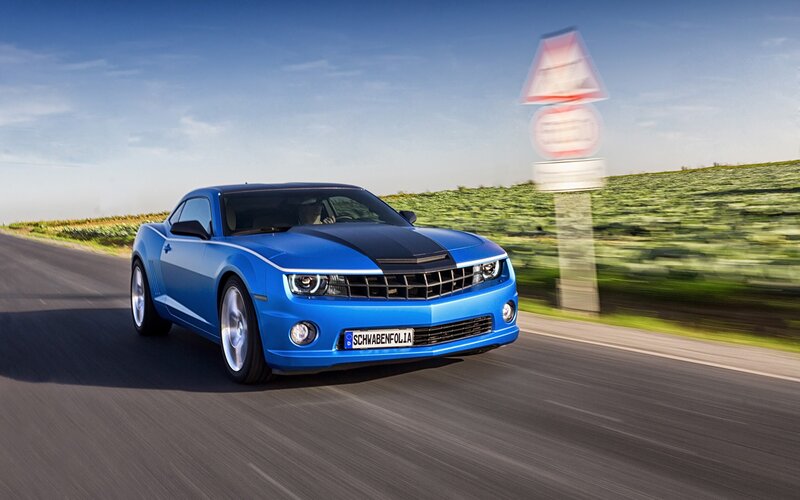 Blue Camaro on a country road