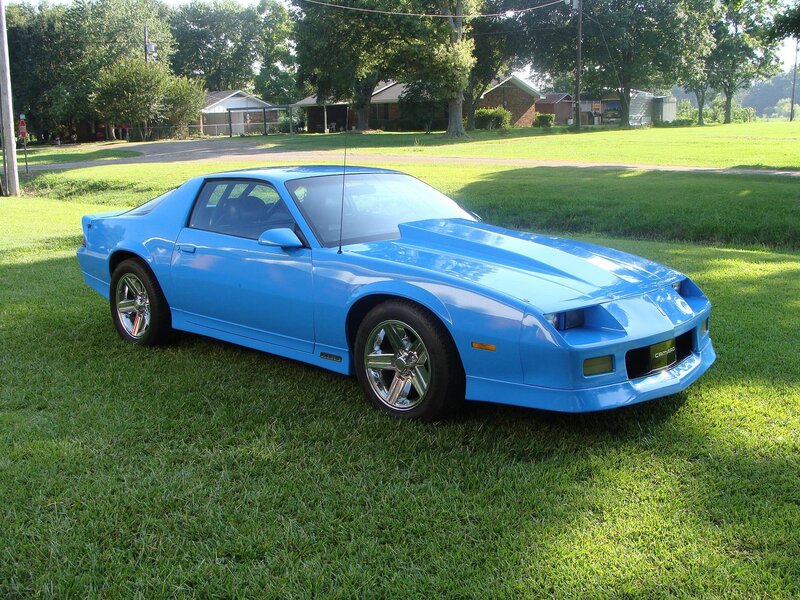 Blue Camaro on a lawn