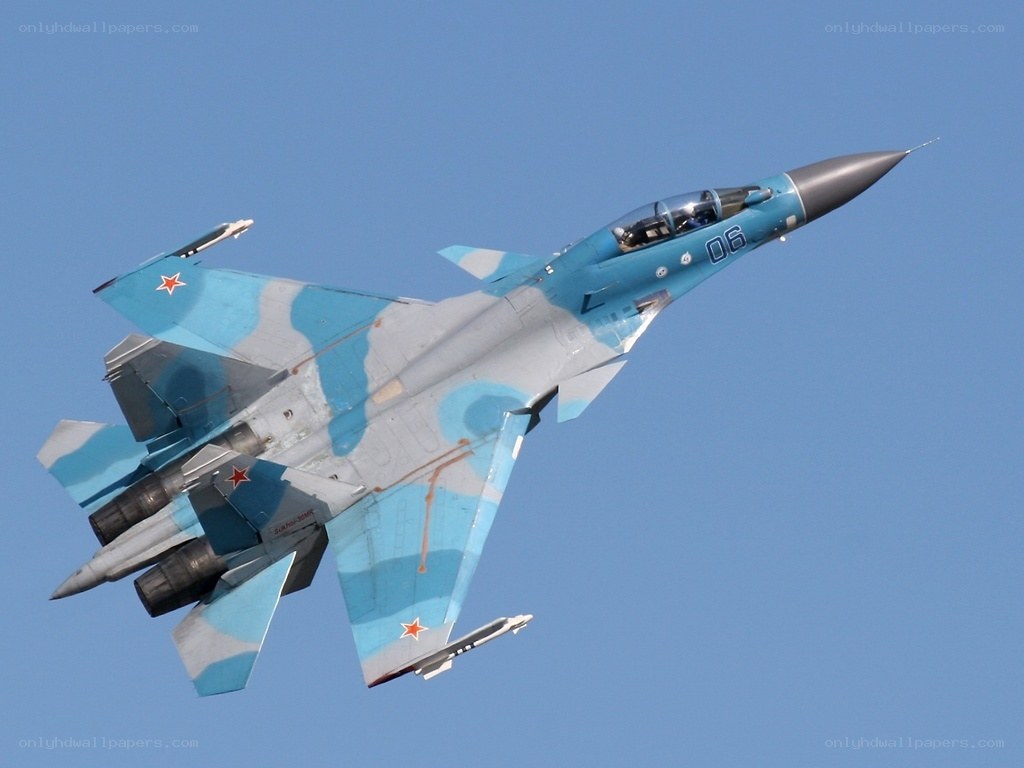 Blue camouflaged fighter jet in flight
