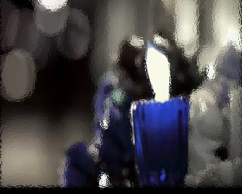 blue candle through textured glass