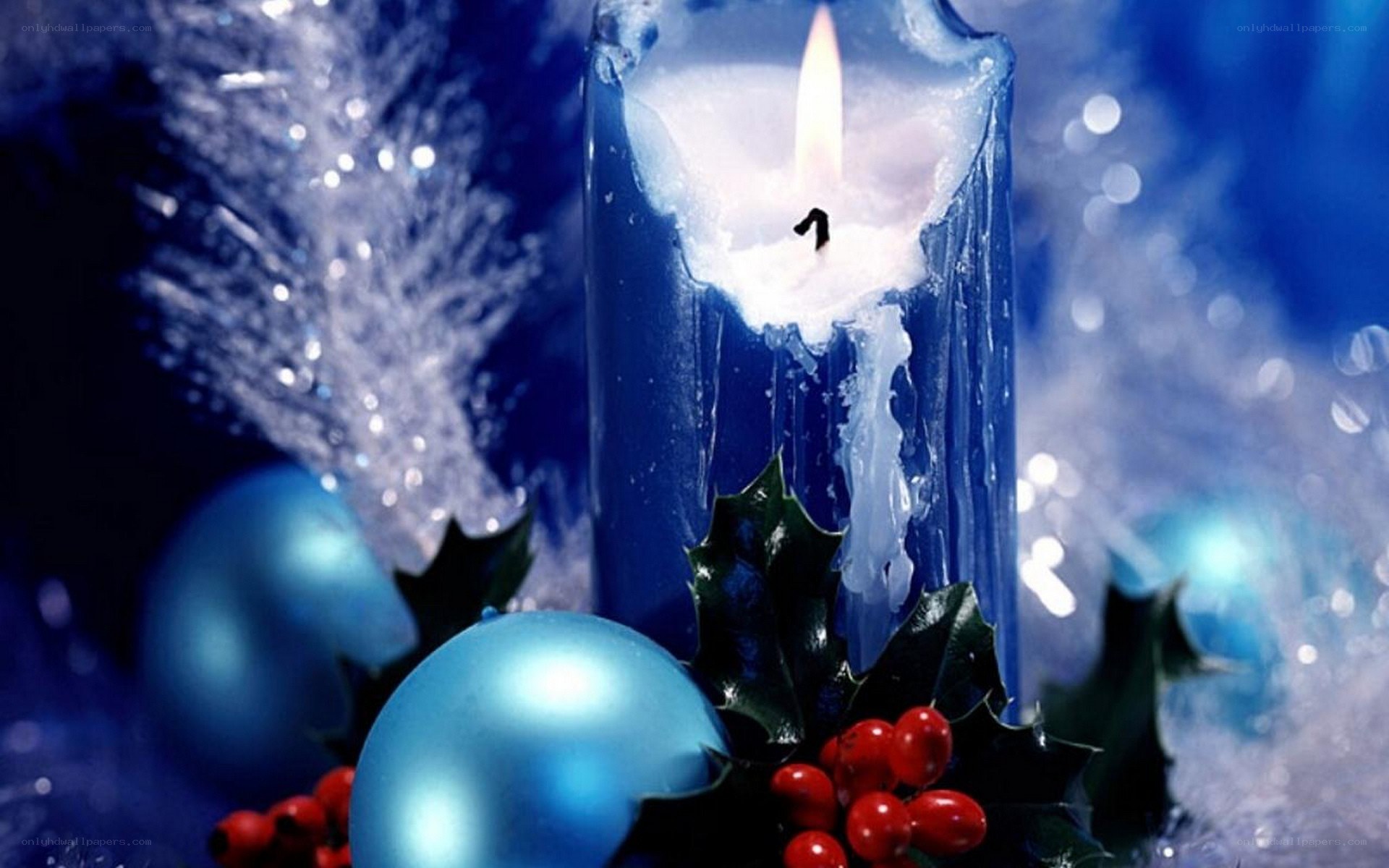 blue candle with holly berries