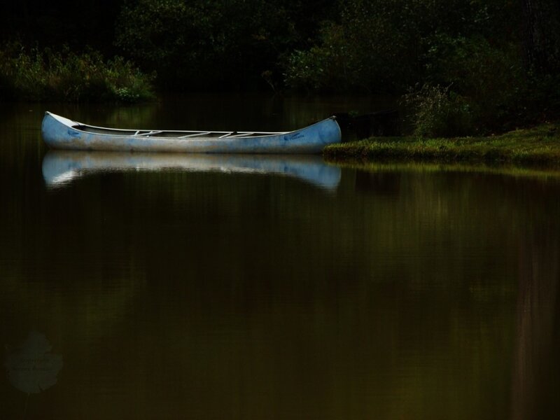 Blue canoe on calm water