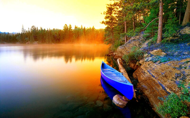 Blue Canoe on Lake Shore — Serene