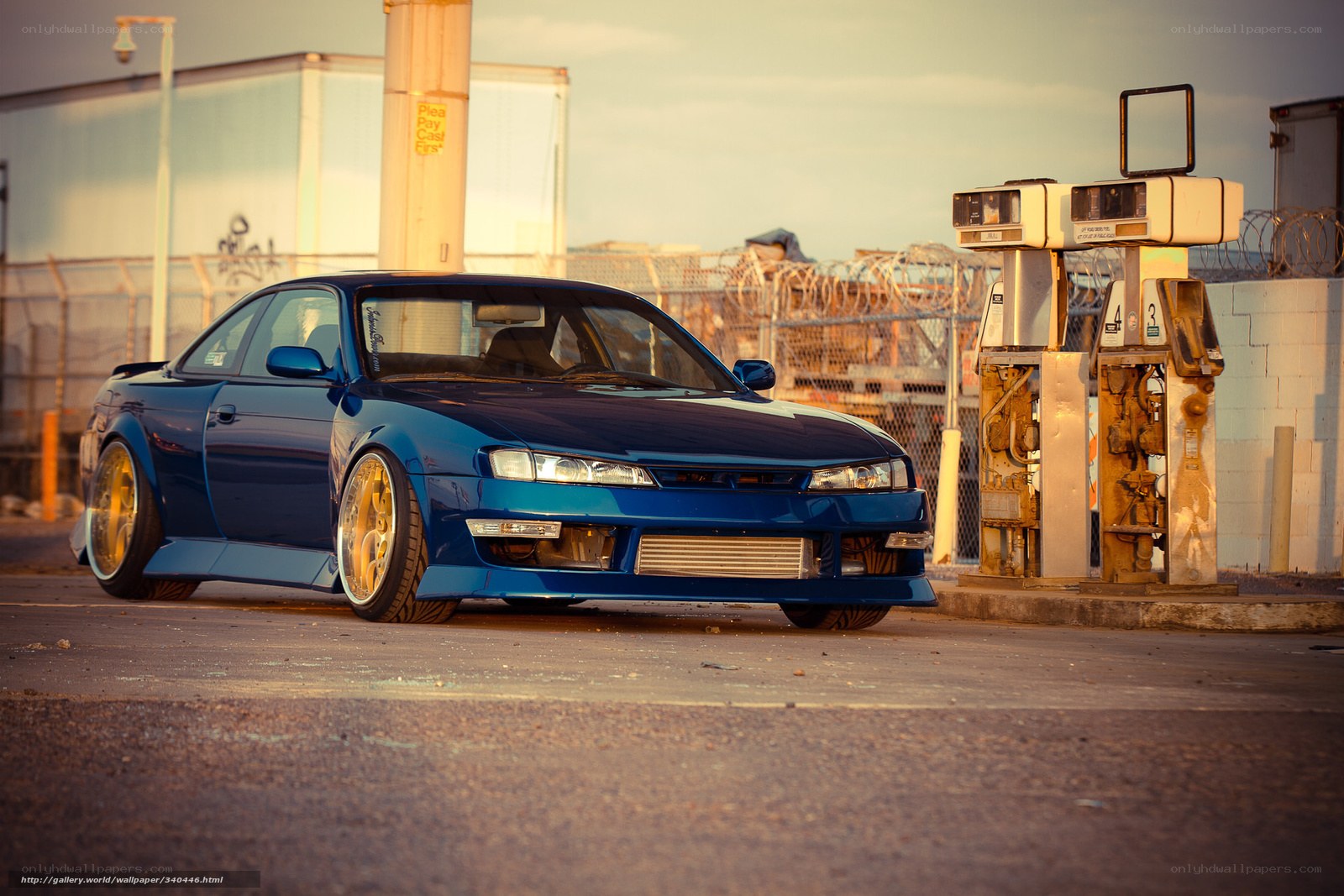 blue car at gas station