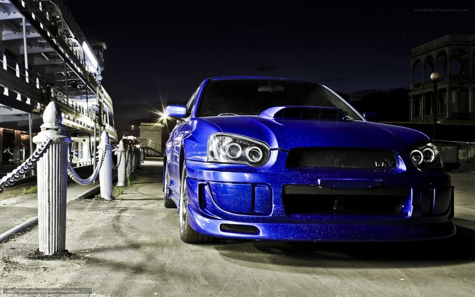 Blue car at night by the dock