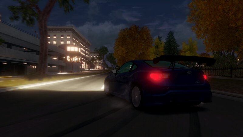 blue car at night in city