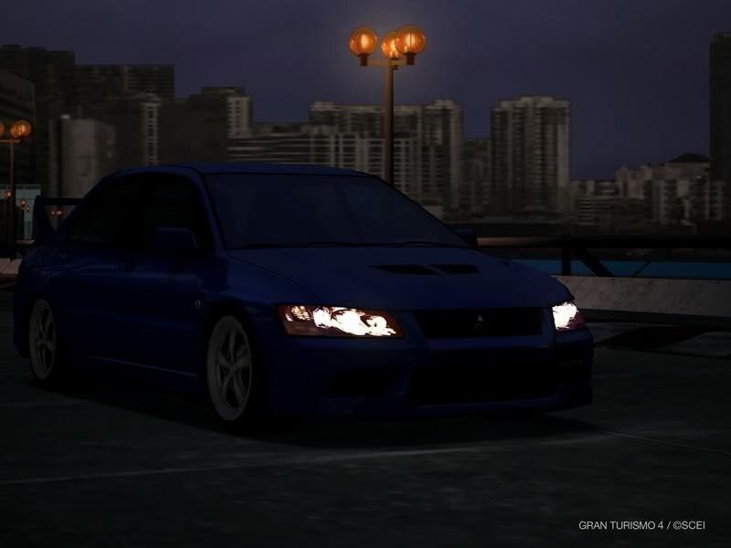 blue car at night in city