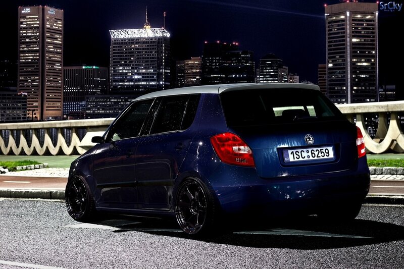 Blue car at night in city