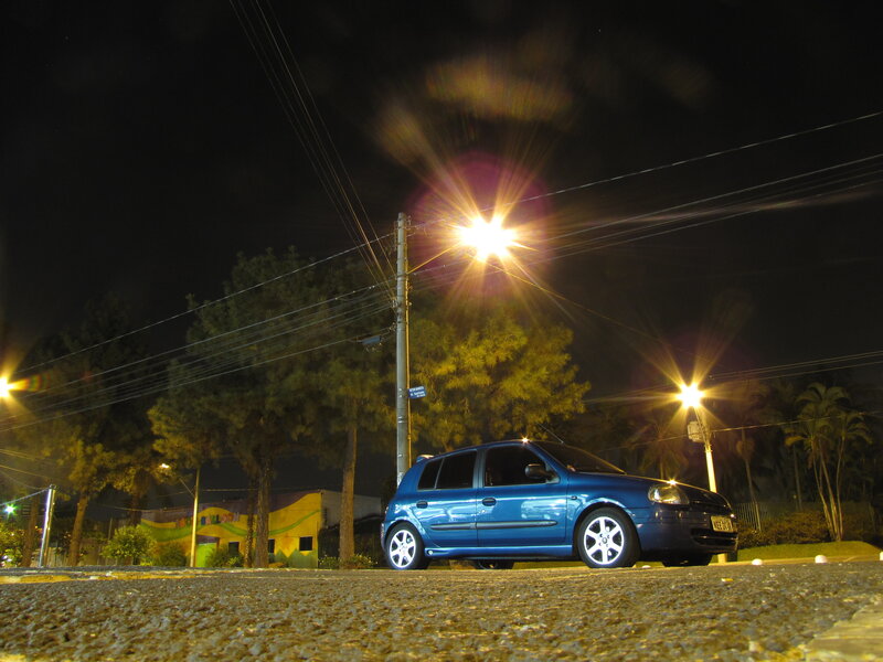 Blue car at night on street