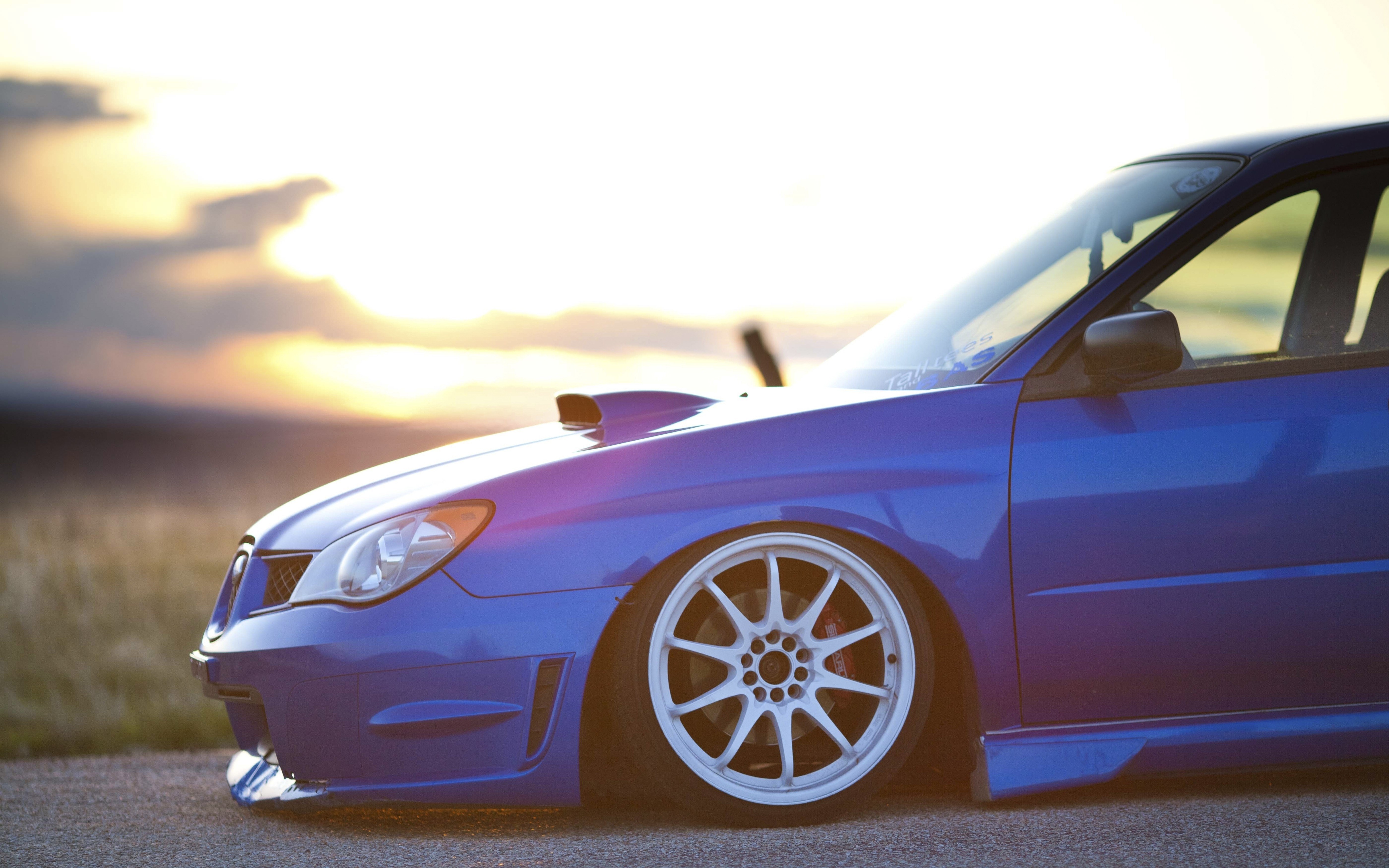 blue car at sunset