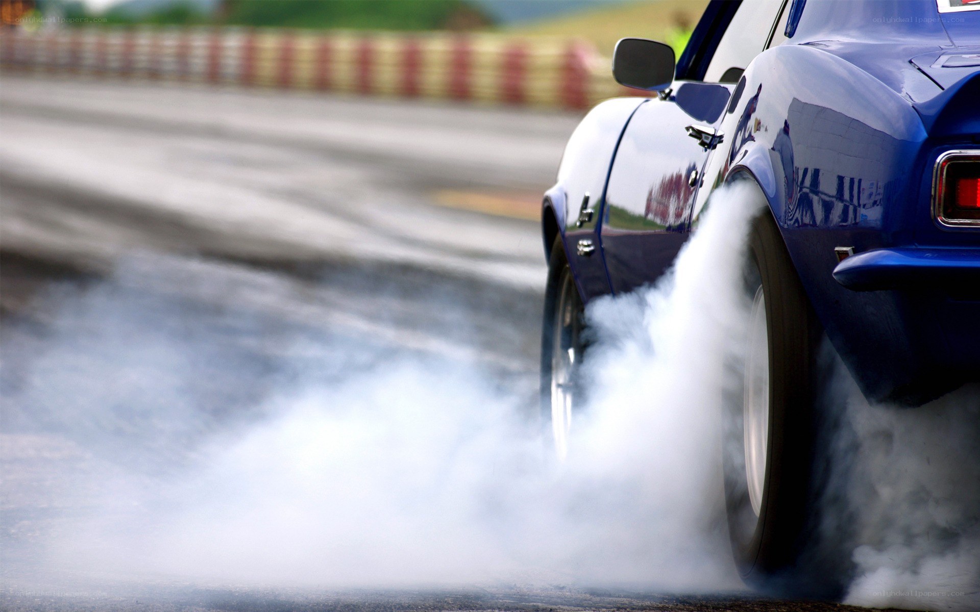 Blue car doing a burnout