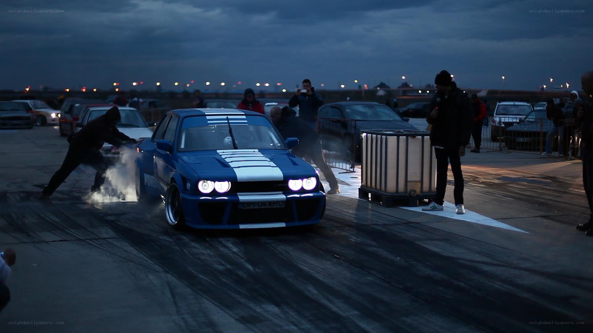 Blue car drifting at night