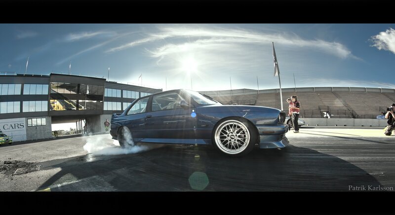 Blue car drifting at racetrack
