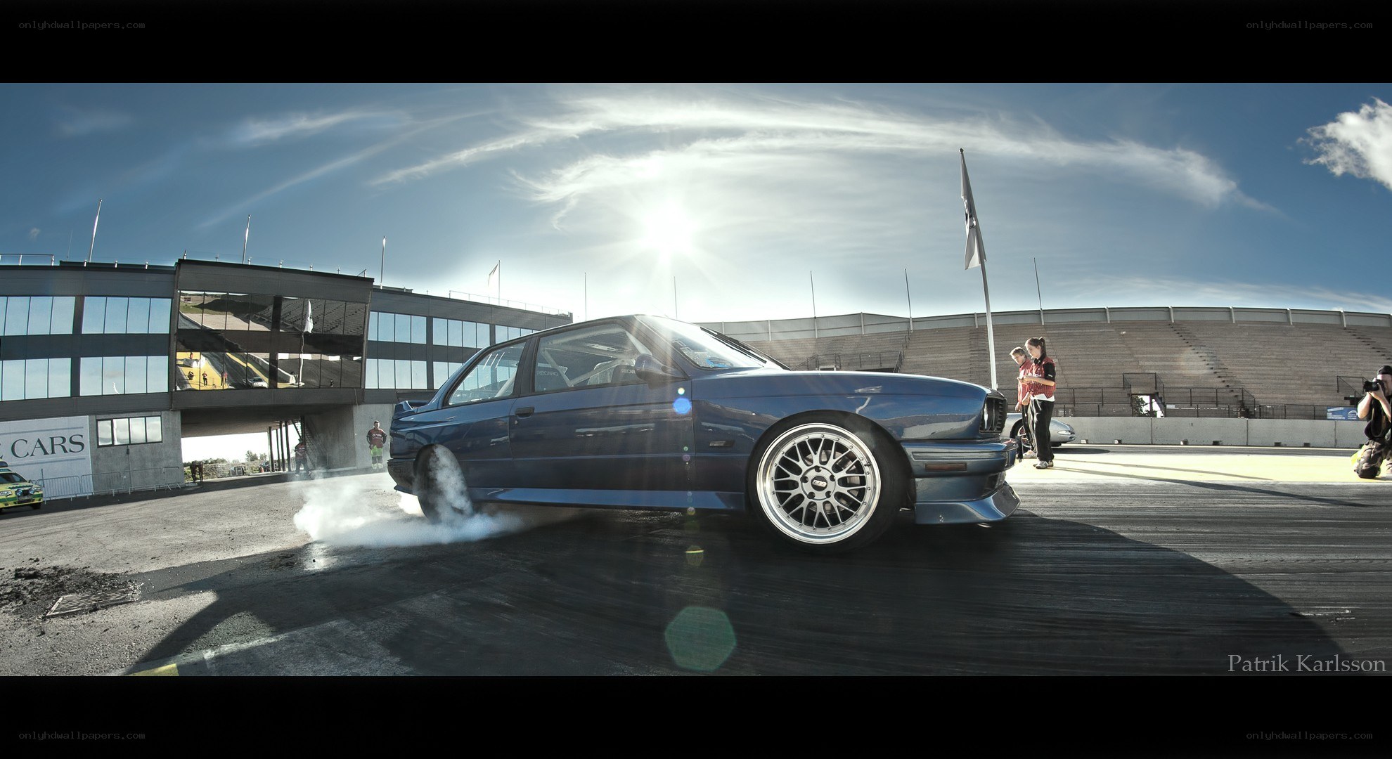 Blue car drifting at racetrack
