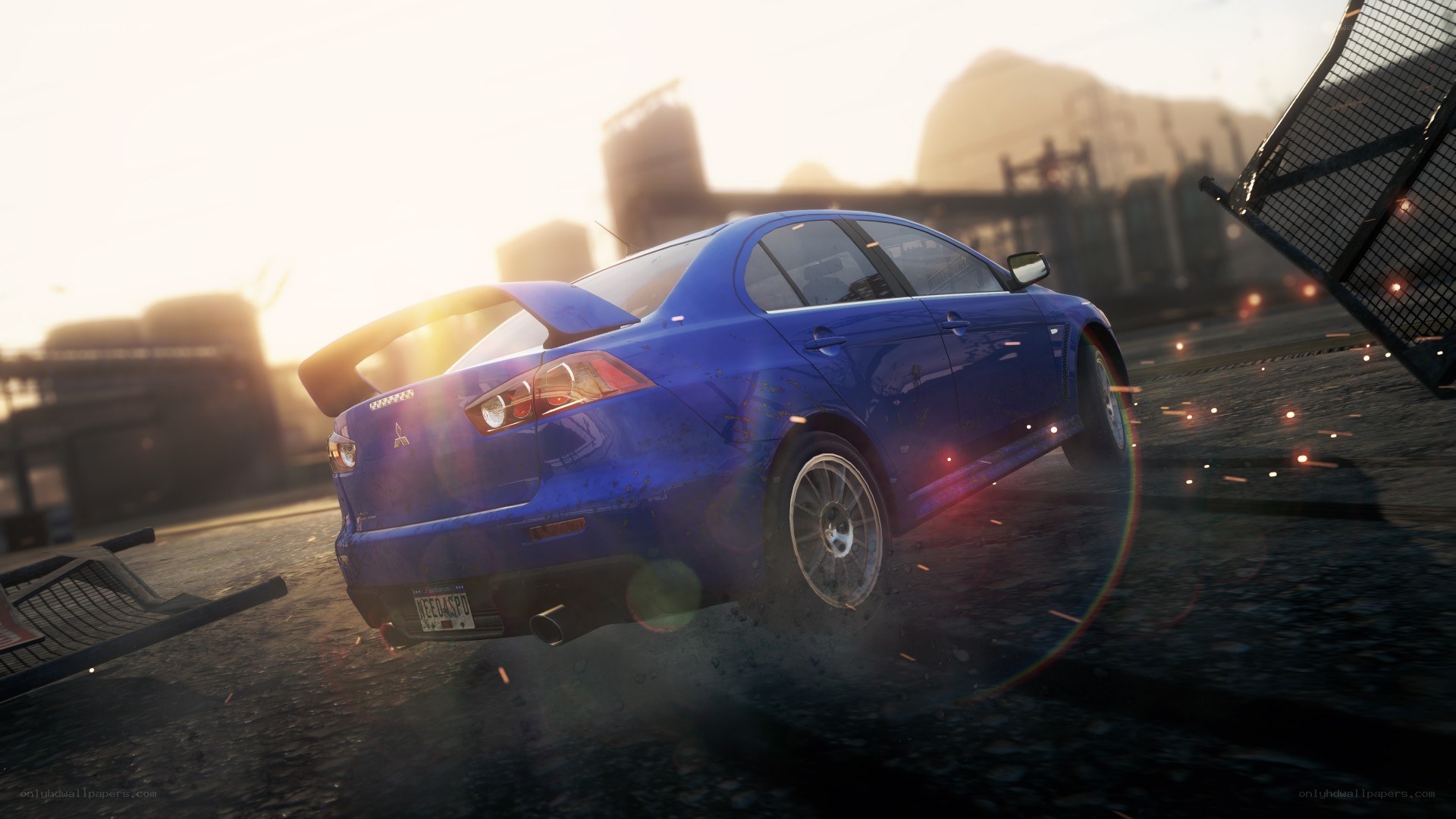 Blue car drifting at sunset