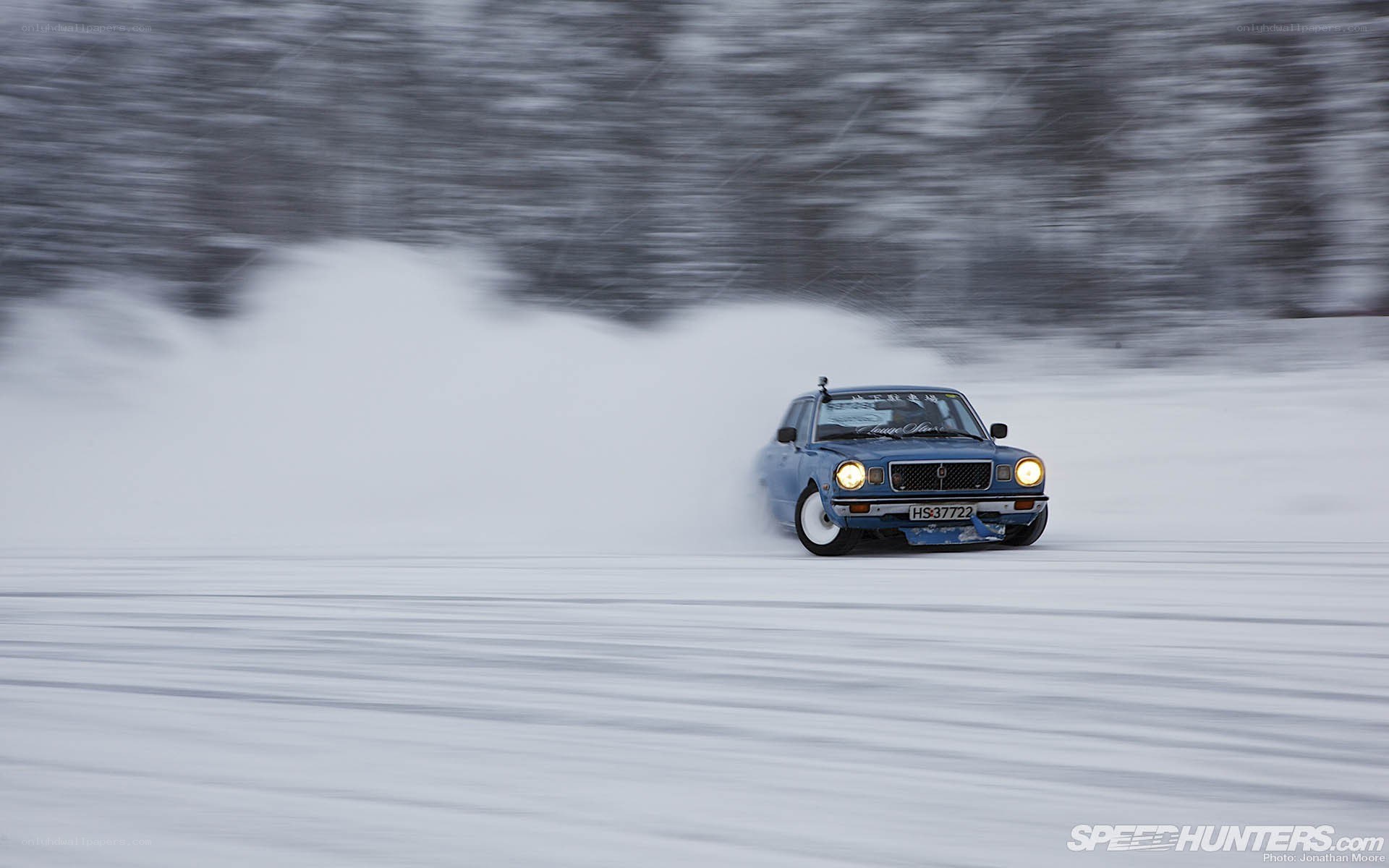 Blue car drifting in snow
