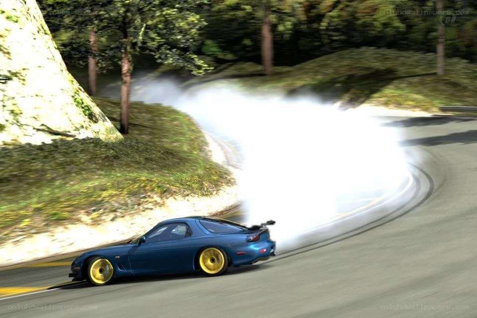 Blue car drifting on a road