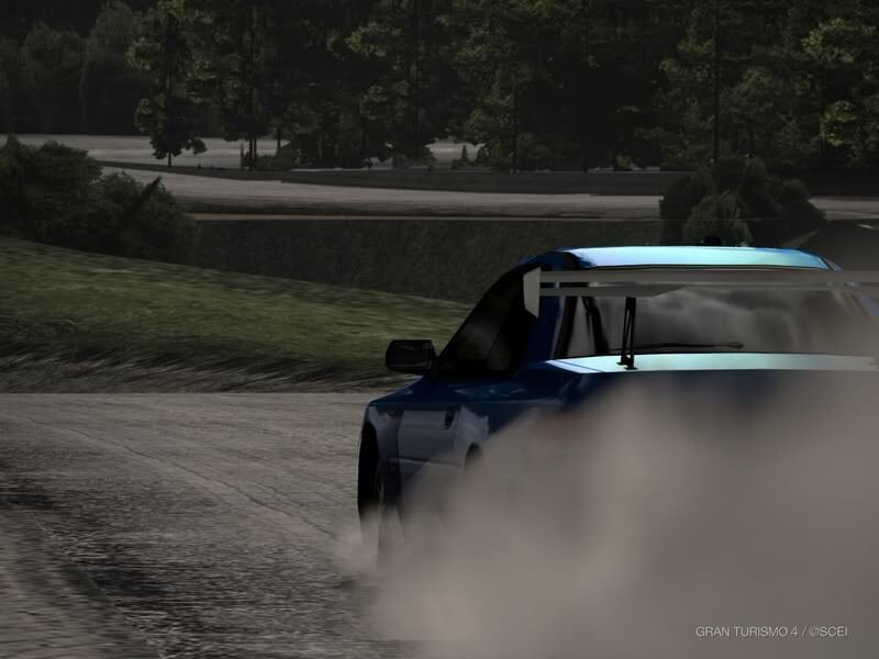 Blue car drifting on dirt