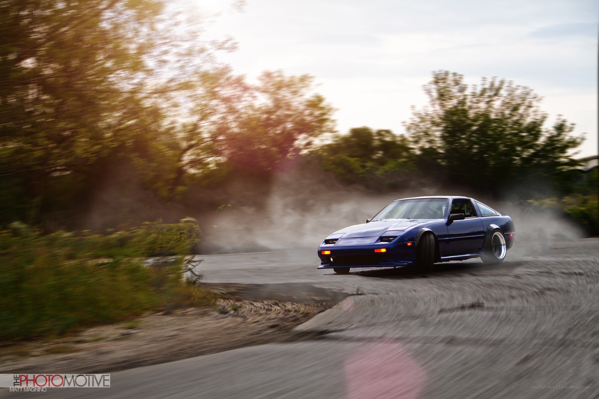 Blue car drifting on road