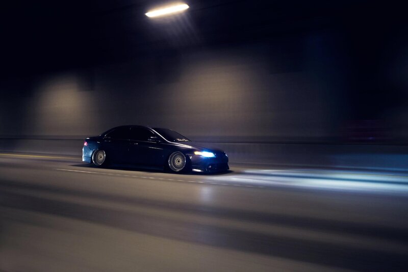 Blue car driving in tunnel