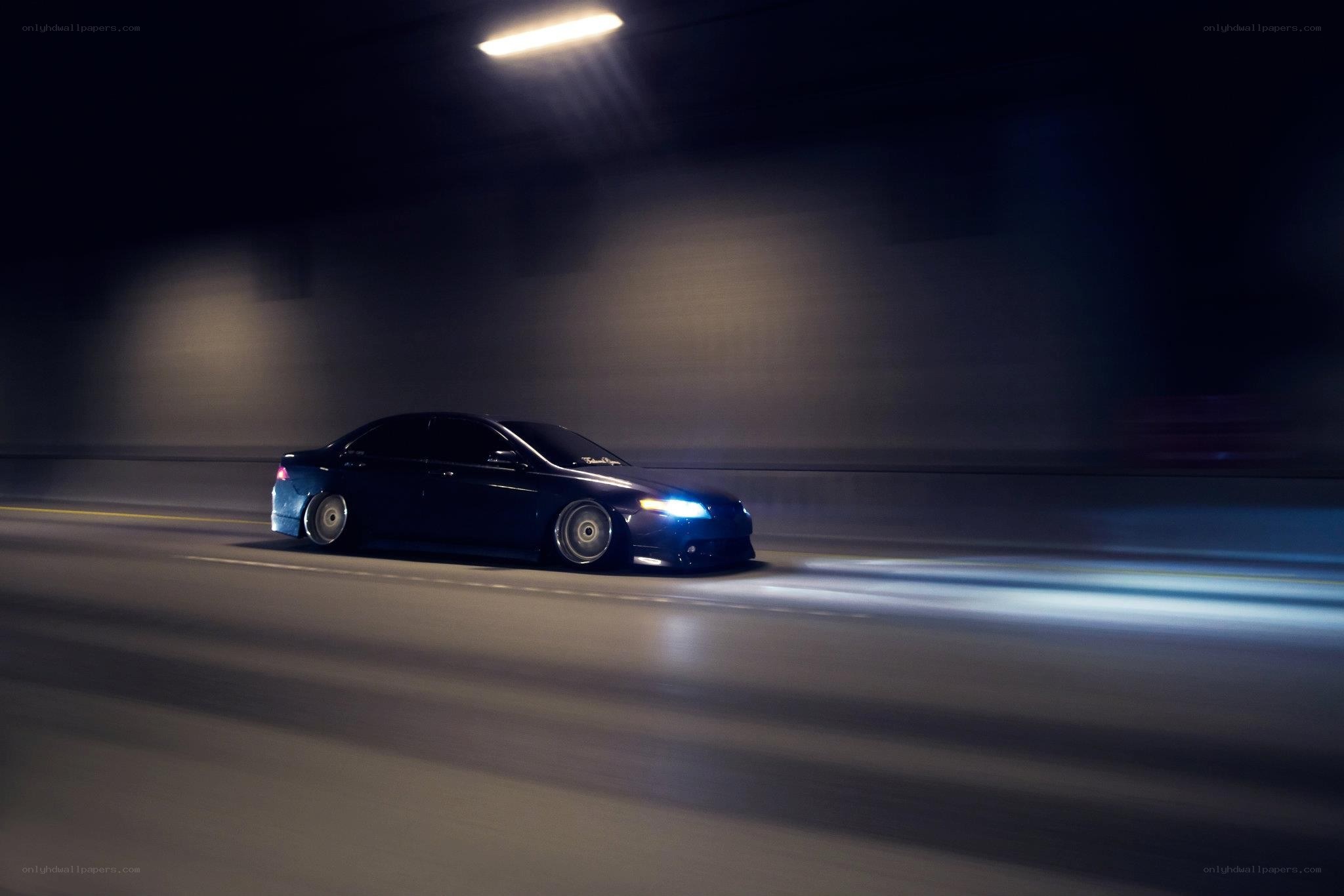 Blue car driving in tunnel