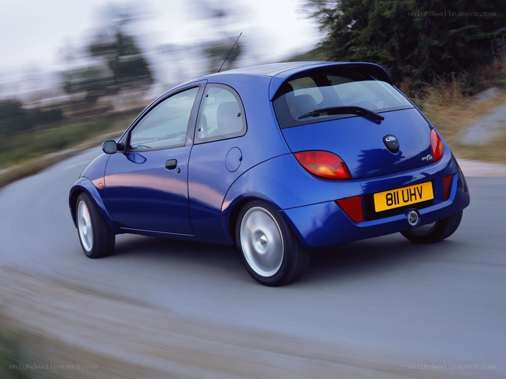 blue car driving on road