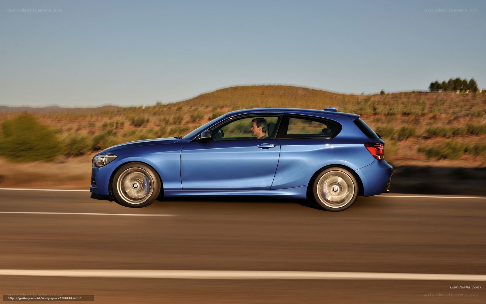 blue car driving on road