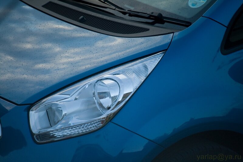 blue car headlight close-up