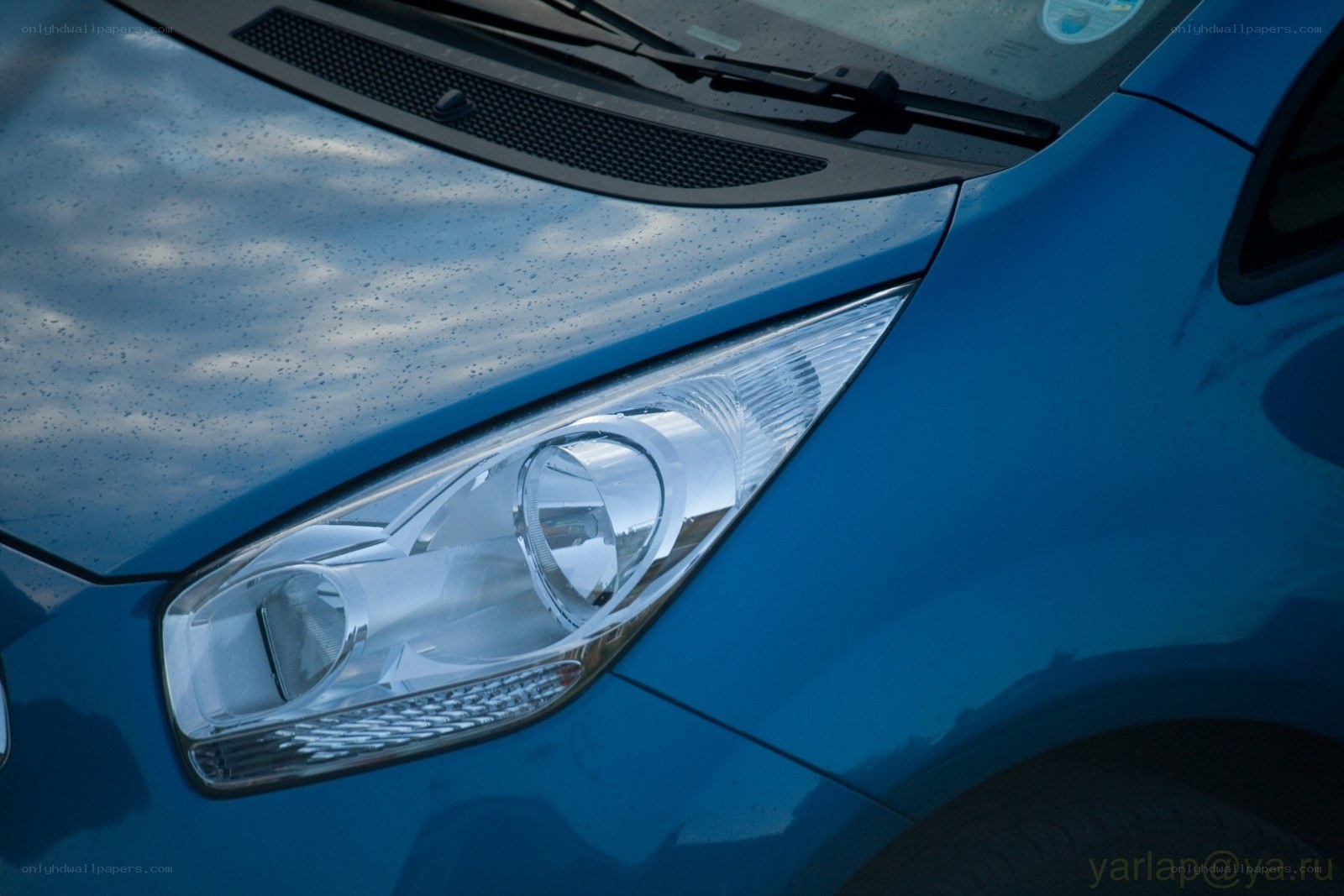 blue car headlight close-up