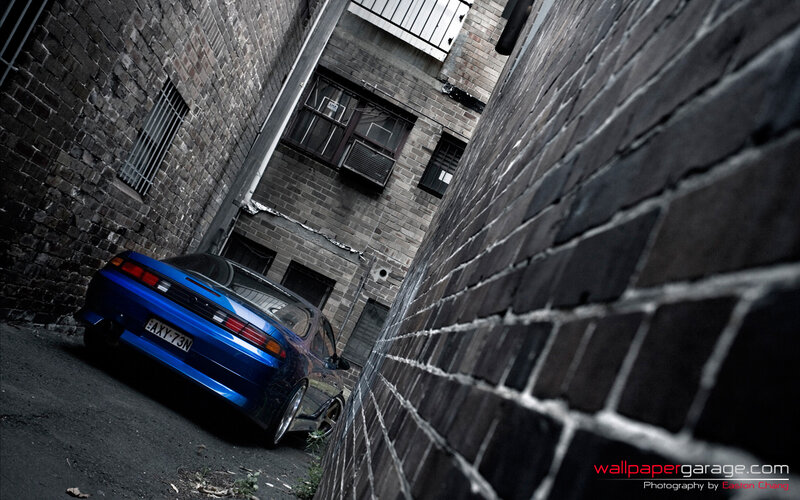 blue car in alleyway